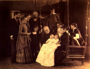 Louis Comfort Tiffany (far left) with his parents (seated), pictured holding Tiffany's twin daughters Louise and Julia